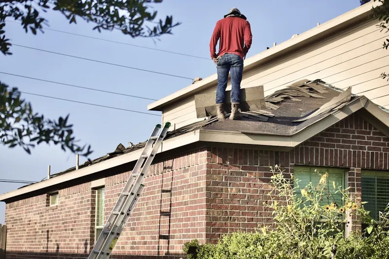 Professional roofer working on a residential roof in Narod